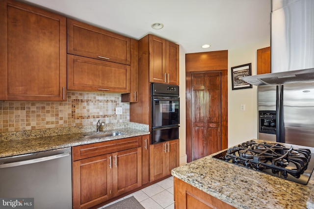 kitchen with sink, dishwasher, tasteful backsplash, light stone countertops, and black gas stovetop