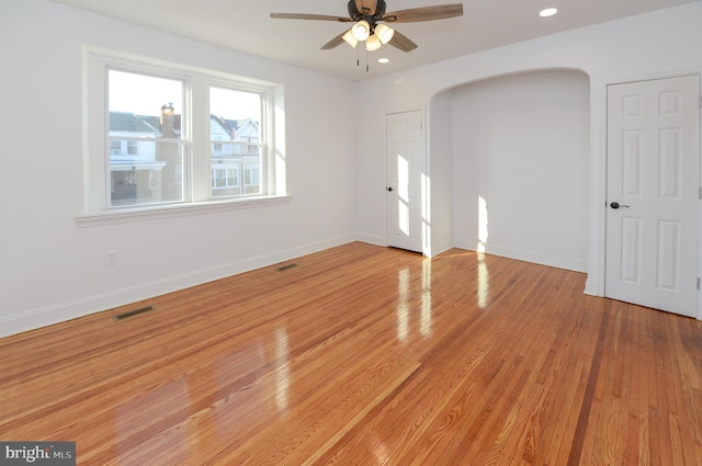 spare room featuring ceiling fan and light hardwood / wood-style flooring