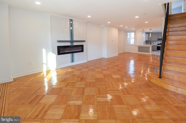 unfurnished living room with light parquet floors