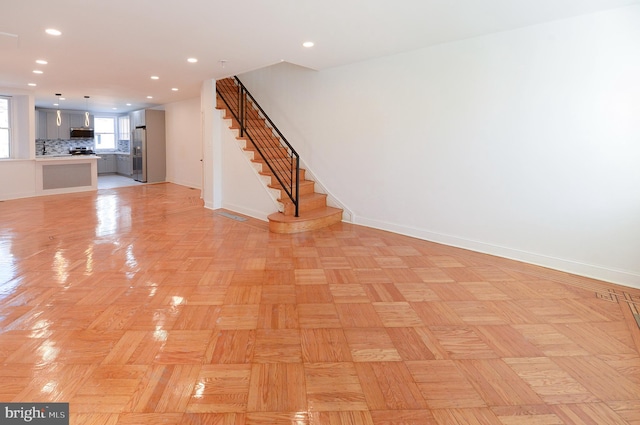 unfurnished living room featuring light parquet flooring