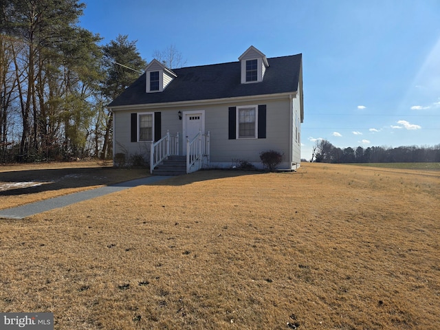 cape cod-style house featuring a front yard