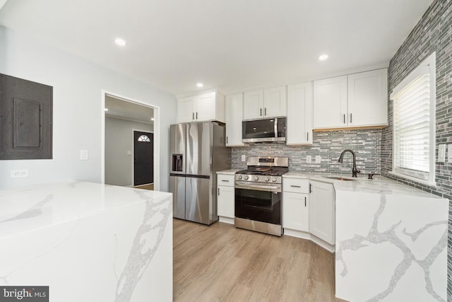 kitchen with white cabinetry, appliances with stainless steel finishes, and sink