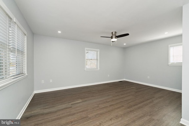 unfurnished room featuring dark hardwood / wood-style floors and ceiling fan