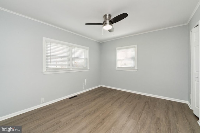 unfurnished room with crown molding, ceiling fan, and dark hardwood / wood-style flooring