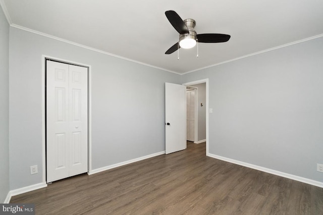 unfurnished bedroom with dark hardwood / wood-style flooring, crown molding, a closet, and ceiling fan