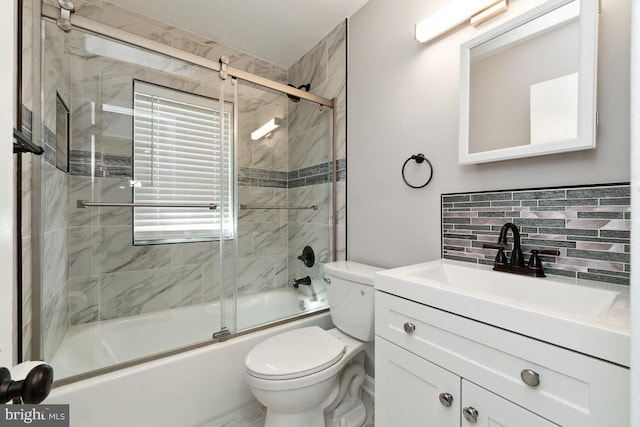 full bathroom featuring enclosed tub / shower combo, toilet, vanity, and decorative backsplash