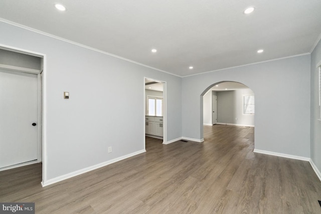 spare room featuring dark hardwood / wood-style flooring and ornamental molding