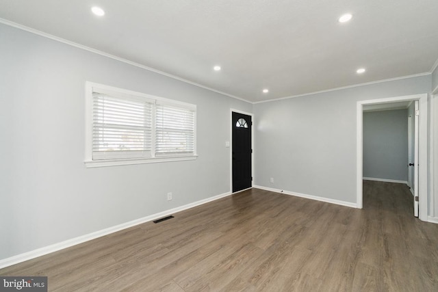 interior space with dark wood-type flooring and ornamental molding