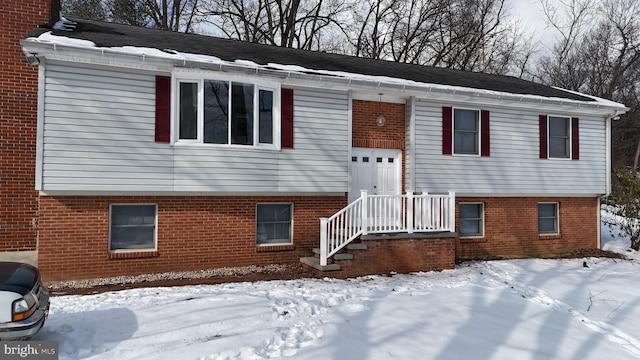 bi-level home featuring brick siding