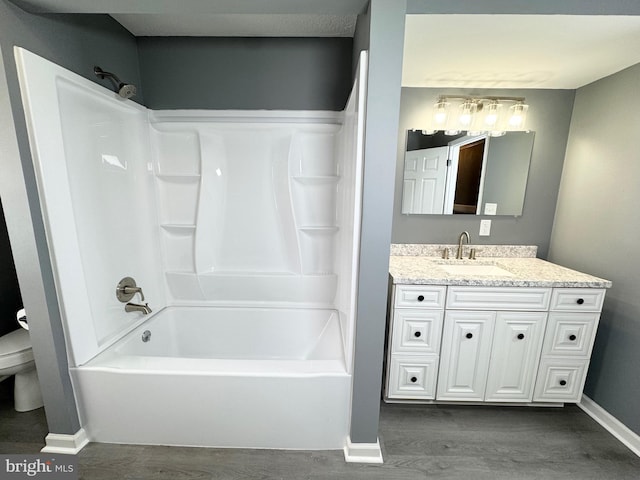 full bathroom featuring shower / tub combination, hardwood / wood-style floors, vanity, and toilet