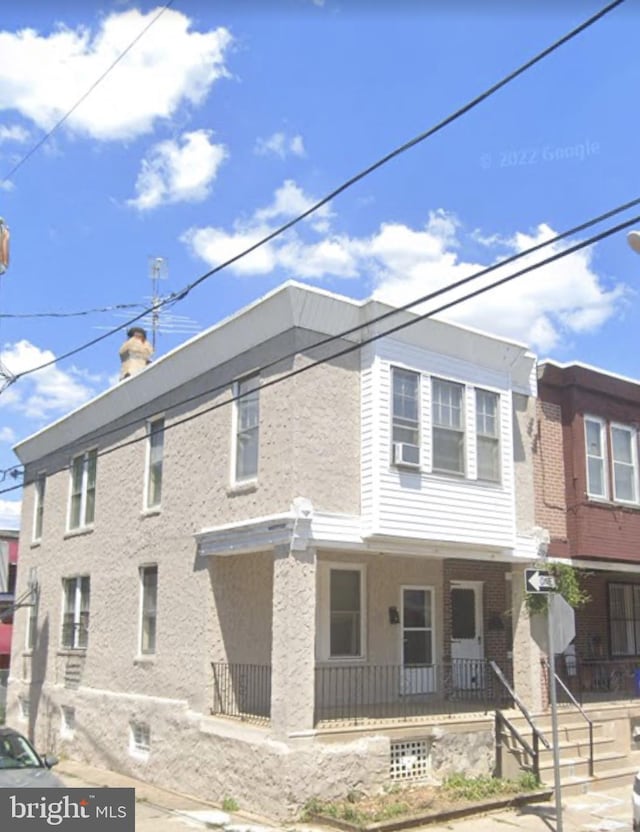 view of front of house featuring cooling unit and covered porch