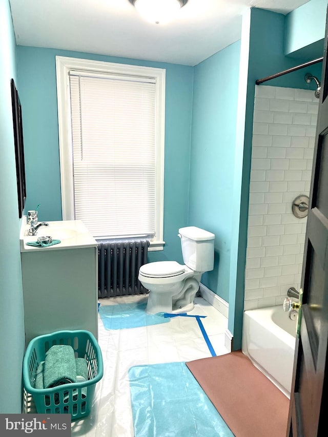 full bathroom with vanity, radiator, tub / shower combination, and toilet