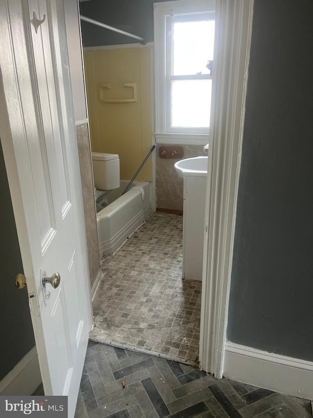 full bathroom featuring vanity, bathtub / shower combination, and toilet