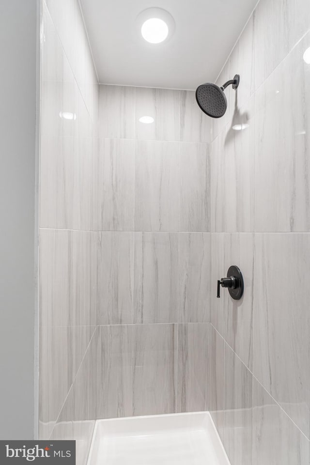 bathroom with tiled shower