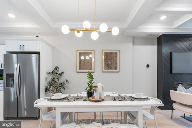 dining space featuring crown molding and beam ceiling