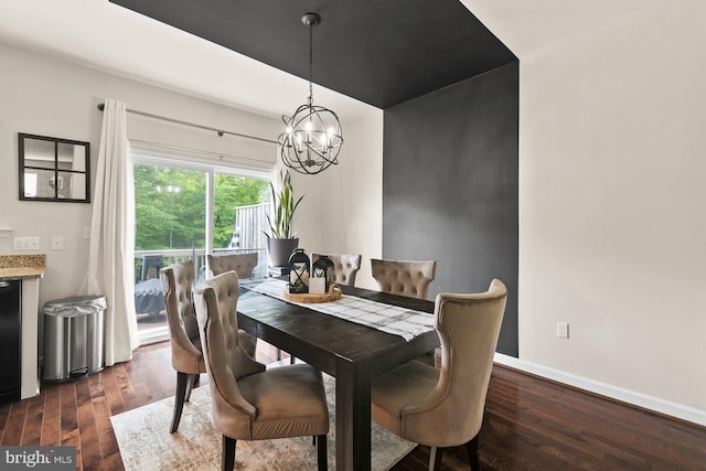 dining area with dark hardwood / wood-style floors and a chandelier