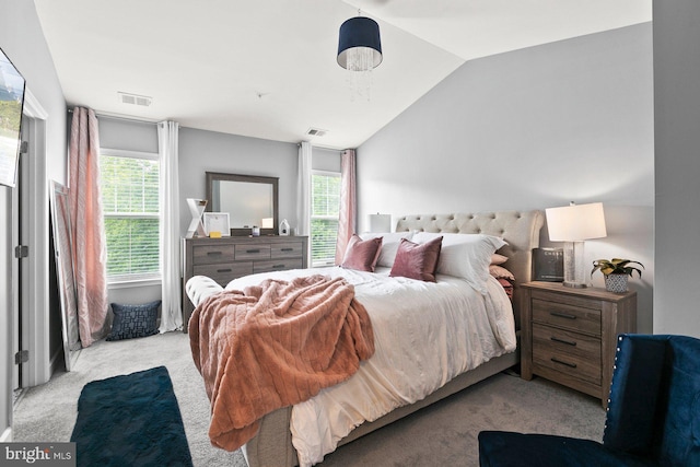 bedroom with lofted ceiling and light colored carpet