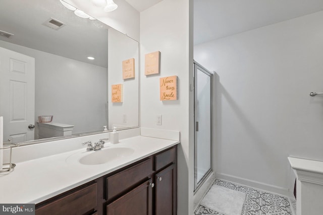 bathroom featuring vanity, toilet, and an enclosed shower