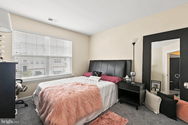 bedroom featuring dark colored carpet