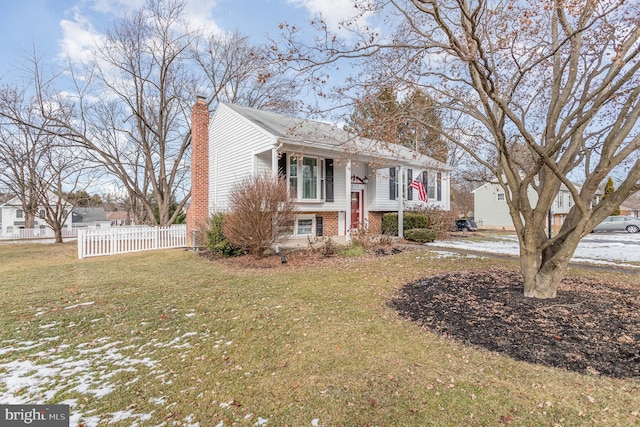 split foyer home with a front lawn