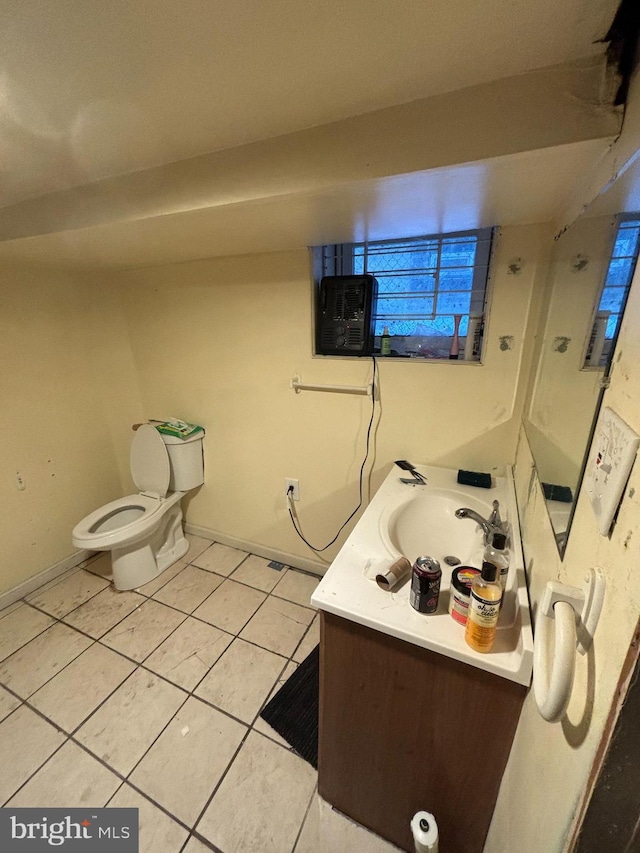 bathroom featuring vanity, tile patterned floors, and toilet