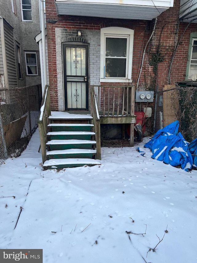 view of snow covered property entrance