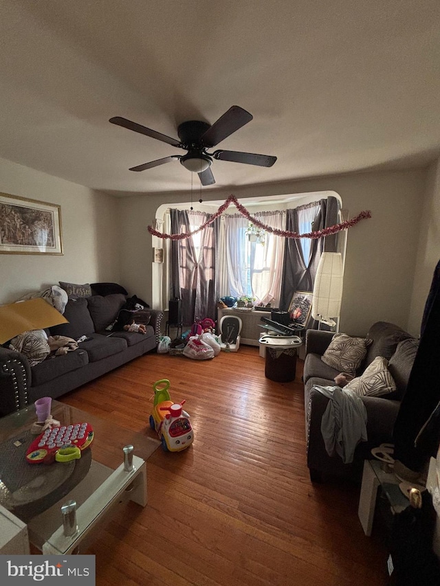 living room with hardwood / wood-style flooring and ceiling fan