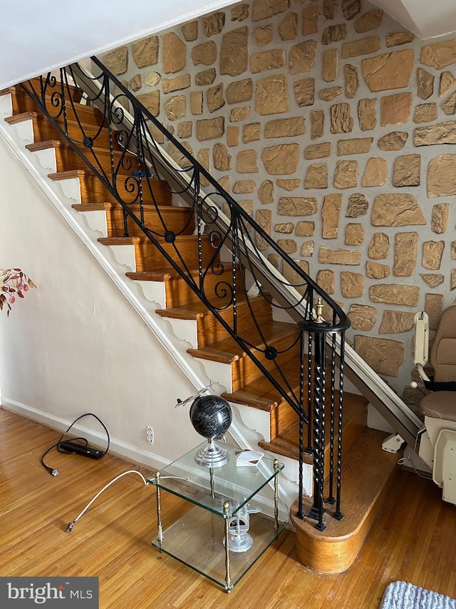 stairs featuring hardwood / wood-style floors