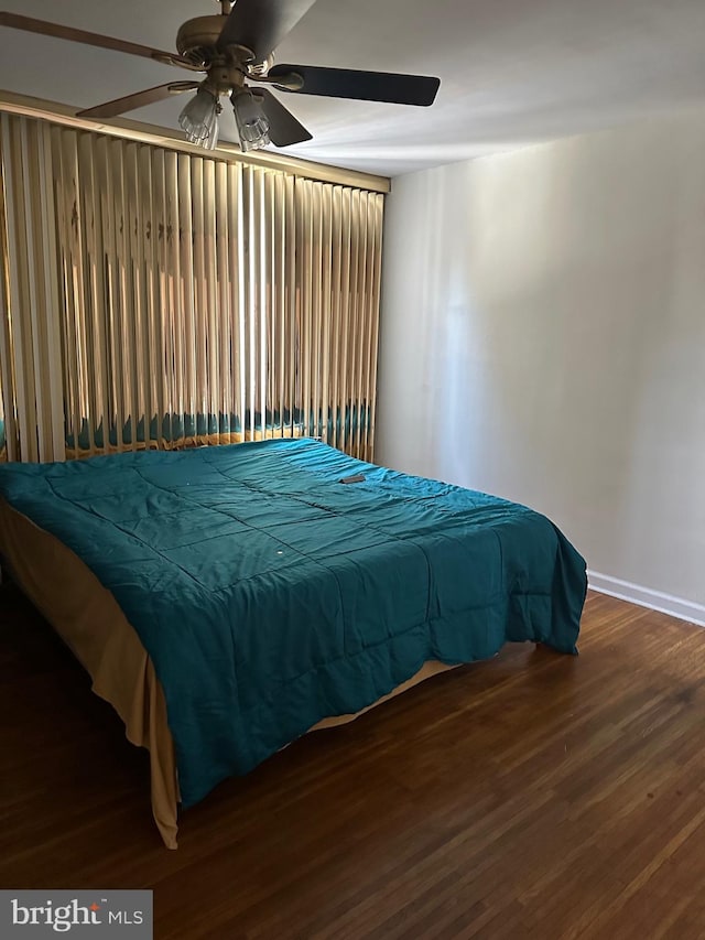 bedroom with dark wood-type flooring and ceiling fan