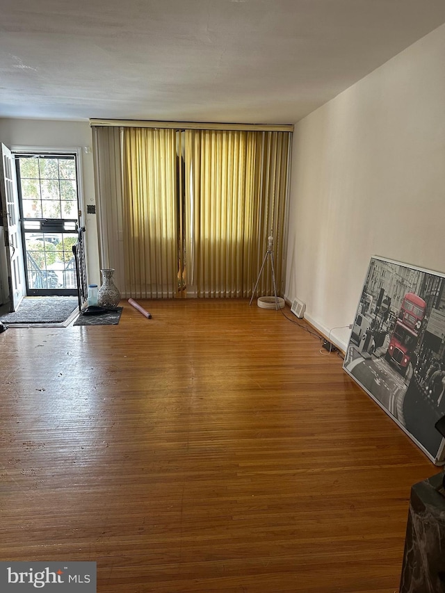 unfurnished room with wood-type flooring