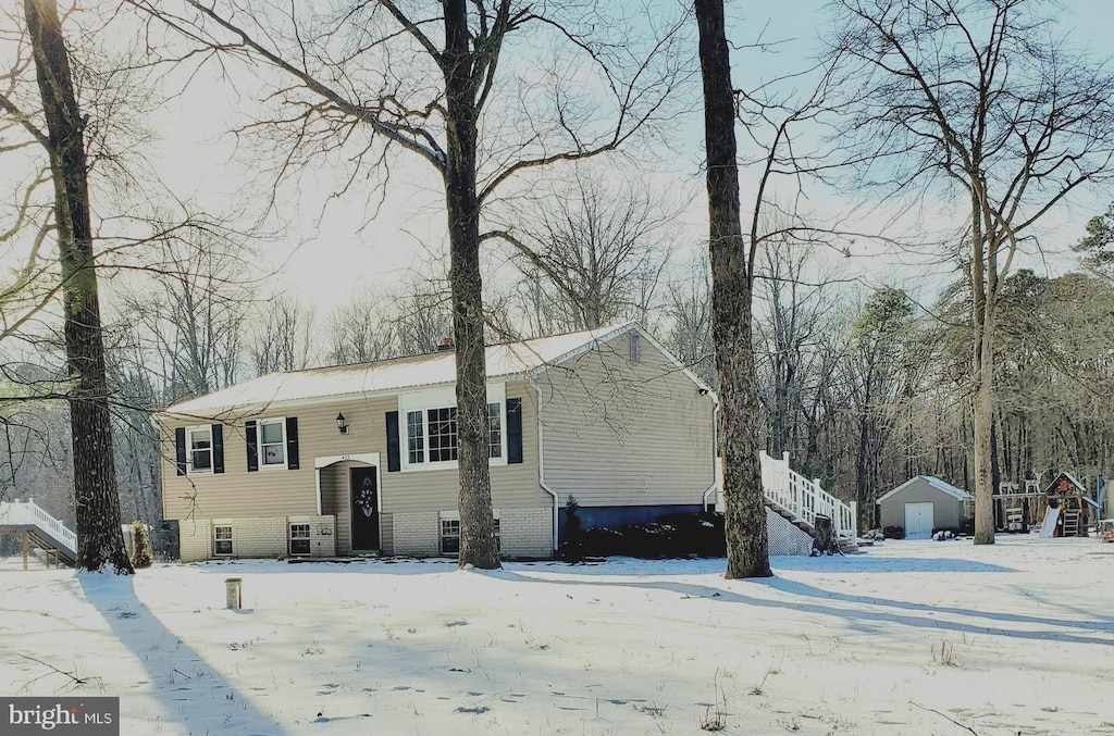 view of front of home featuring a shed