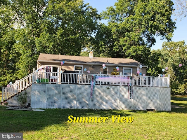 back of house featuring a yard and a deck