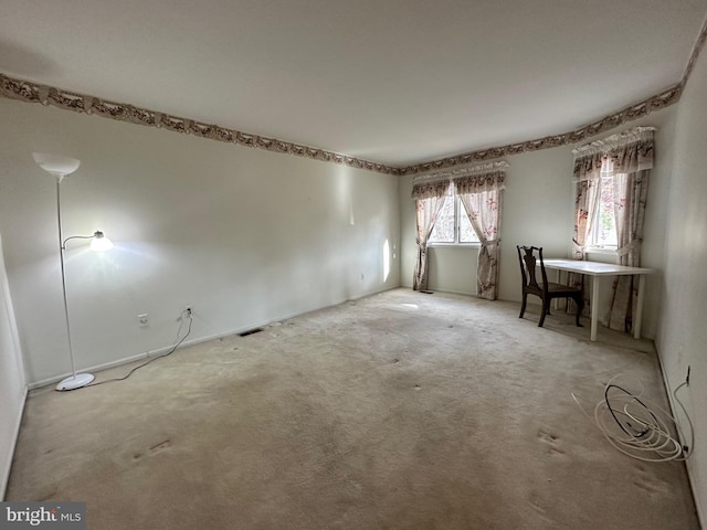 carpeted empty room with visible vents