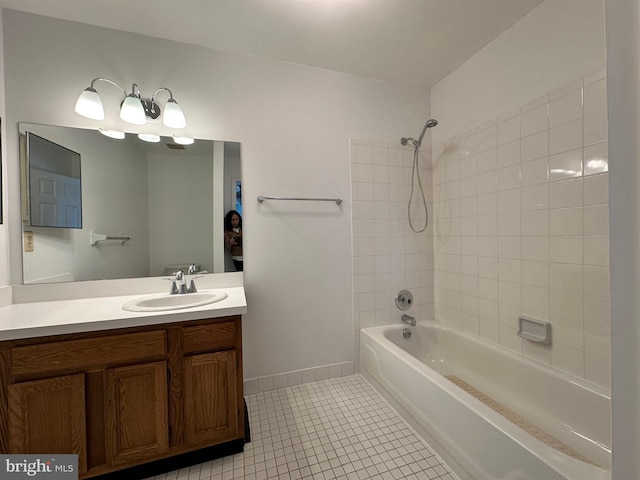 bathroom featuring tile patterned flooring, vanity, baseboards, and shower / bathing tub combination