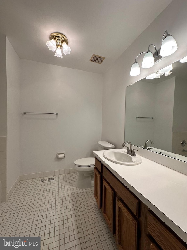 bathroom featuring toilet, tile patterned flooring, visible vents, and vanity