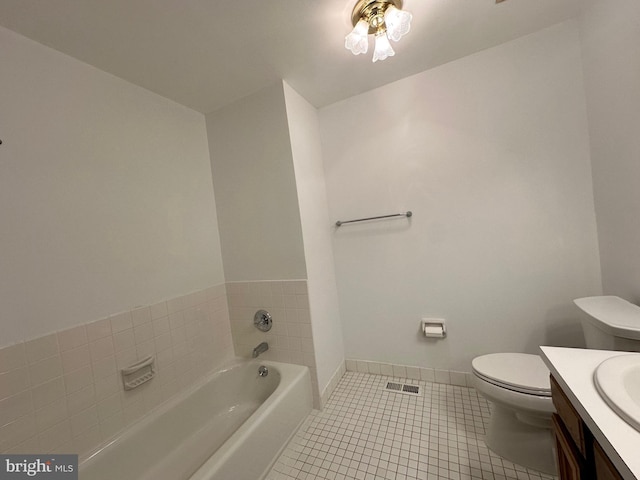 bathroom featuring visible vents, toilet, tile patterned floors, vanity, and a bath