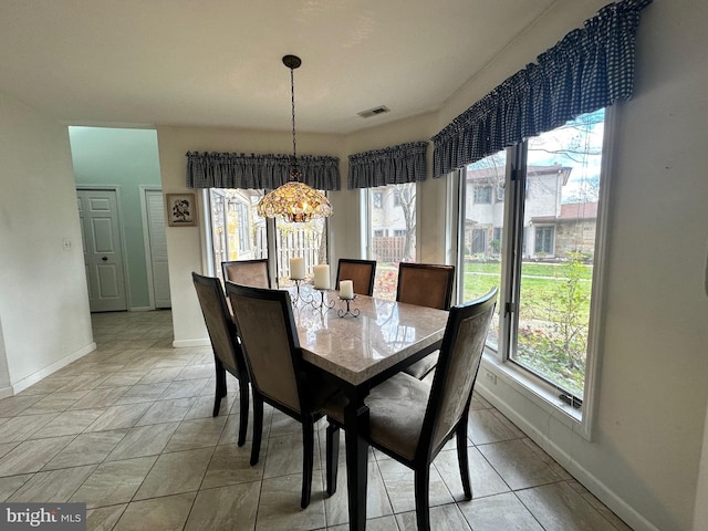 dining space featuring plenty of natural light and baseboards