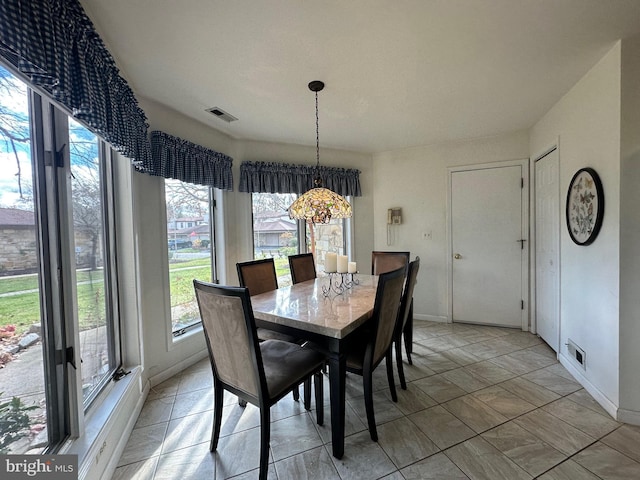 dining room with visible vents and baseboards