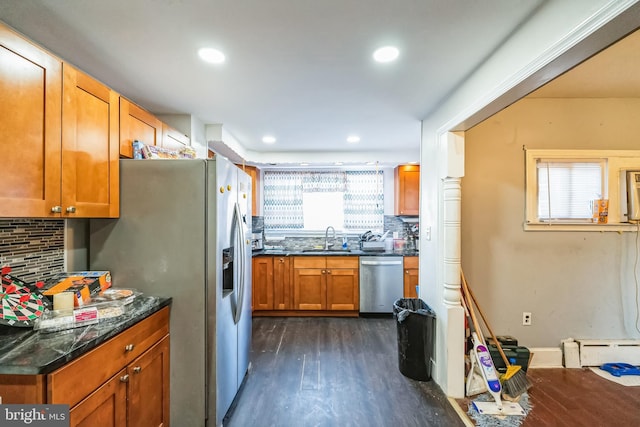 kitchen featuring sink, dark wood-type flooring, backsplash, stainless steel appliances, and a baseboard radiator