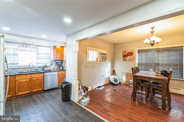 dining space featuring a wall mounted air conditioner, sink, a baseboard heating unit, a notable chandelier, and dark wood-type flooring