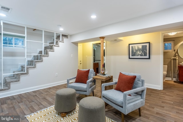 living area with recessed lighting, wood finished floors, visible vents, baseboards, and stairway