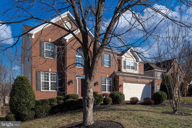 traditional-style house featuring a front lawn, an attached garage, and brick siding