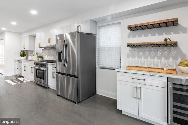 kitchen with wine cooler, white cabinetry, and stainless steel appliances