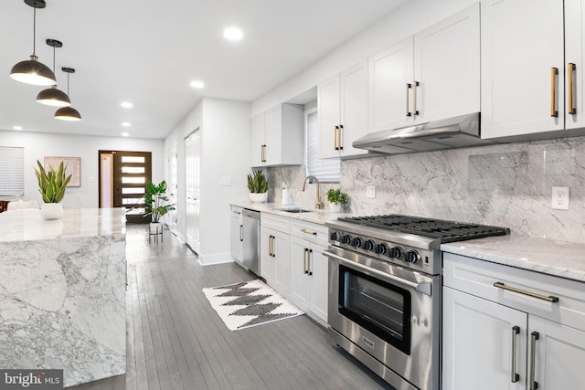 kitchen featuring stainless steel appliances, light stone countertops, sink, and white cabinets