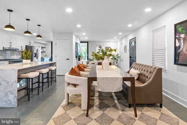 dining area with dark hardwood / wood-style flooring