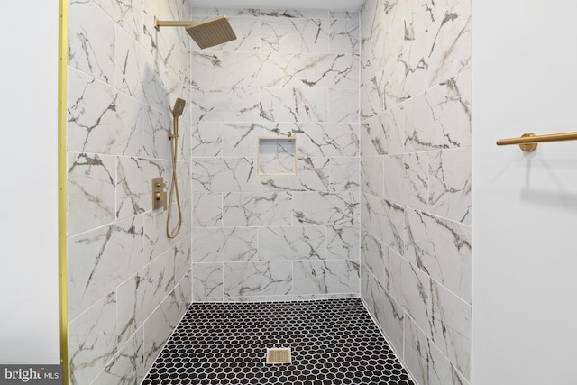 bathroom with a tile shower