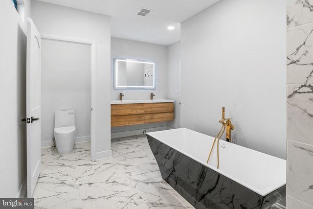 bathroom featuring a tub to relax in, toilet, and vanity