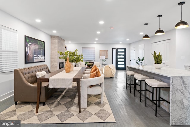 dining area featuring hardwood / wood-style floors and a fireplace