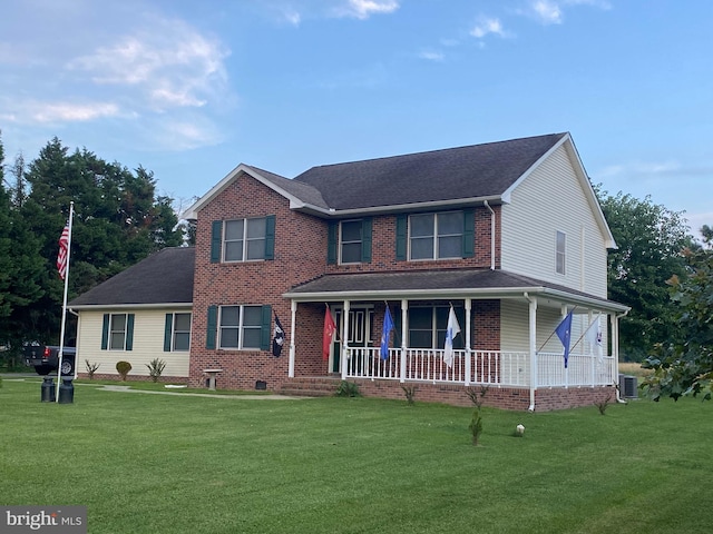 view of front facade with a porch, a front lawn, and central air condition unit