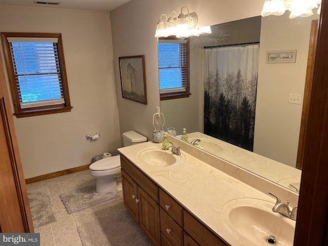 bathroom featuring vanity, toilet, and a shower with shower curtain